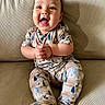Luka is registered to the contest to win money with this photo: baby, child, smiling, happy, pajamas, couch, indoor, clapping, face, person, seated, cute, comfort, cozy, patterned_clothing, infant, portrait, furniture, home, warm_lighting