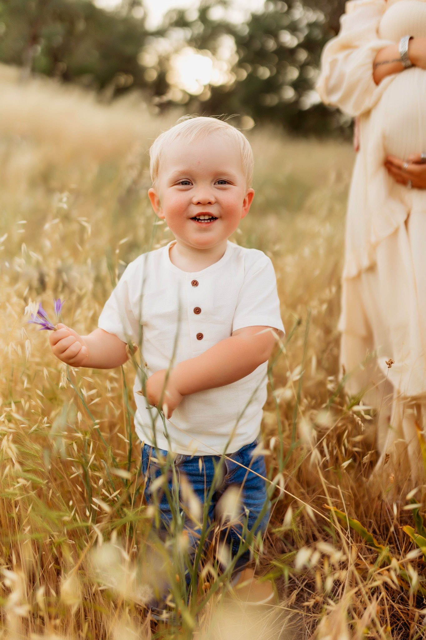 Cole is registered to the contest to win money with this photo: baby, baby_toddler_clothing, child, fun, gesture, grass, grass_family, happy, iris, joy, leaf, meadow, nature, people_in_nature, person, plant, skin, smile, standing, summer