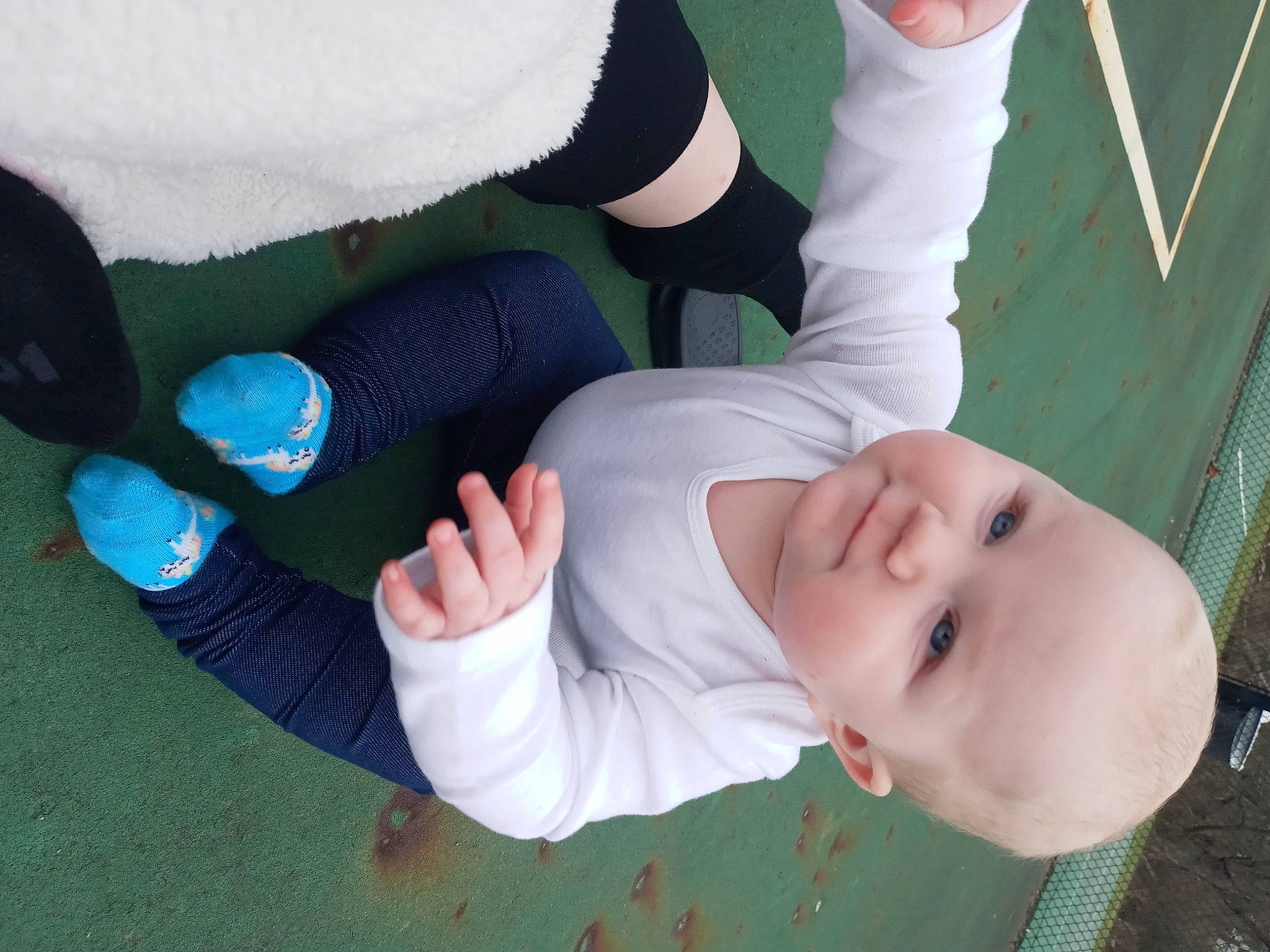 Sabrina is registered to the contest to win money with this photo: arm, baby, child, elbow, finger, fun, gesture, grass, hand, happy, knee, nail, person, plant, sleeve, smile, sock, thumb, toddler, tree