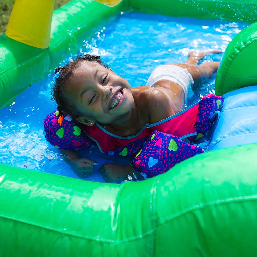 Legacy is registered to the contest to win money with this photo: aqua, bathing, blue, child, electric_blue, fun, games, happy, inflatable, joy, leisure, leisure_centre, nonbuilding_structure, outdoor_recreation, person, play, product, recreation, smile, swimming_pool