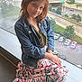 Gracelyn joined the competition — help win amazing prizes! casual_clothing, child, city_view, cute, daytime, denim_jacket, fashion, floral_skirt, girl, indoor, natural_light, portrait, posing, red_hair, relaxed, sitting, smile, urban_background, window, young_person