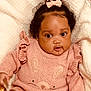 Anyla is registered to the contest to win money with this photo: baby, infant, child, pink_sweater, bow, curly_hair, cute, face, eyes, blanket, soft_texture, cozy, portrait, clothing, closeup, adorable, young_child, smile, cute_outfit, indoor