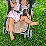 child, toddler, stroller, sleeping, pink_dress, grass, outdoor, baby, maclaren, footwear, nature, greenery, resting, summer, sunlight, cute, relaxation, person, baby_stroller, infant