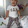 Salome joined the competition — help win amazing prizes! child, toddler, girl, portrait, standing, smiling, open_mouth, bow, leopard_print, pajamas, t_shirt, bedroom, bed, bedding, stuffed_animals, toys, window, indoor, fashion, happy