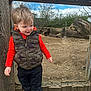 Luca is registered to the contest to win money with this photo: animal, boy, child, clothing, coat, face, head, jacket, male, pants, person, photography, plant, portrait, rock, soil, tree, vest, wood, zoo
