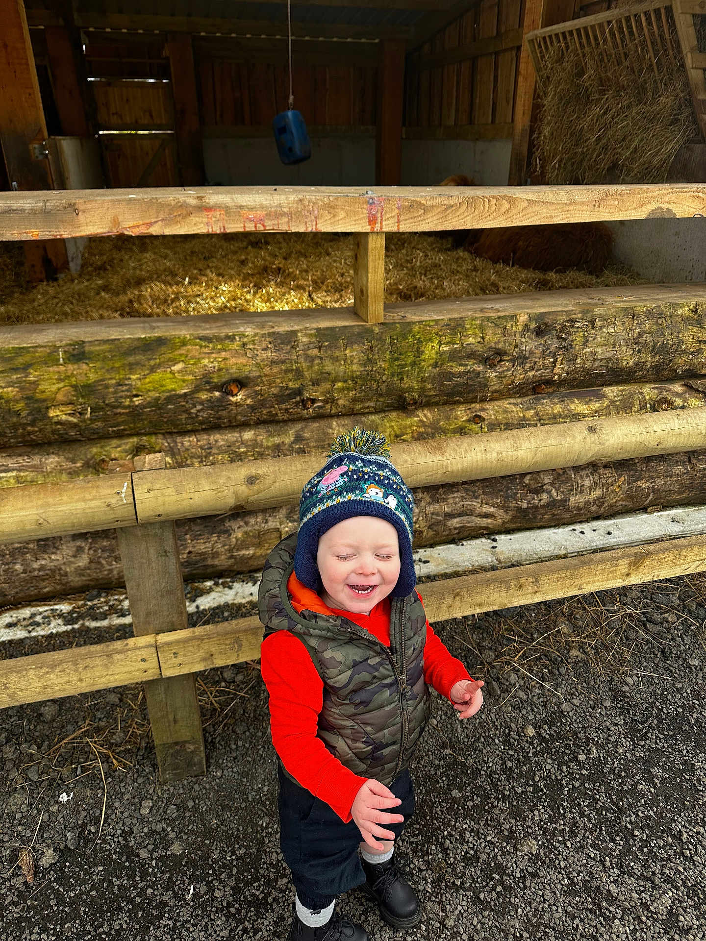 Luca is registered to the contest to win money with this photo: baby, cap, clothing, coat, face, hat, head, hood, hoodie, jacket, jeans, knitwear, pants, person, photography, portrait, soil, sweater, sweatshirt, wood