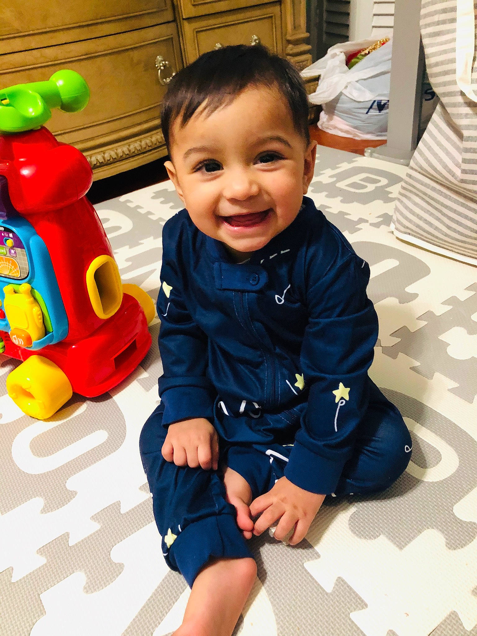 Inayat is registered to the contest to win money with this photo: baby, baby_playing_with_toys, child, joy, male, outerwear, person, play, smile, toddler, toy