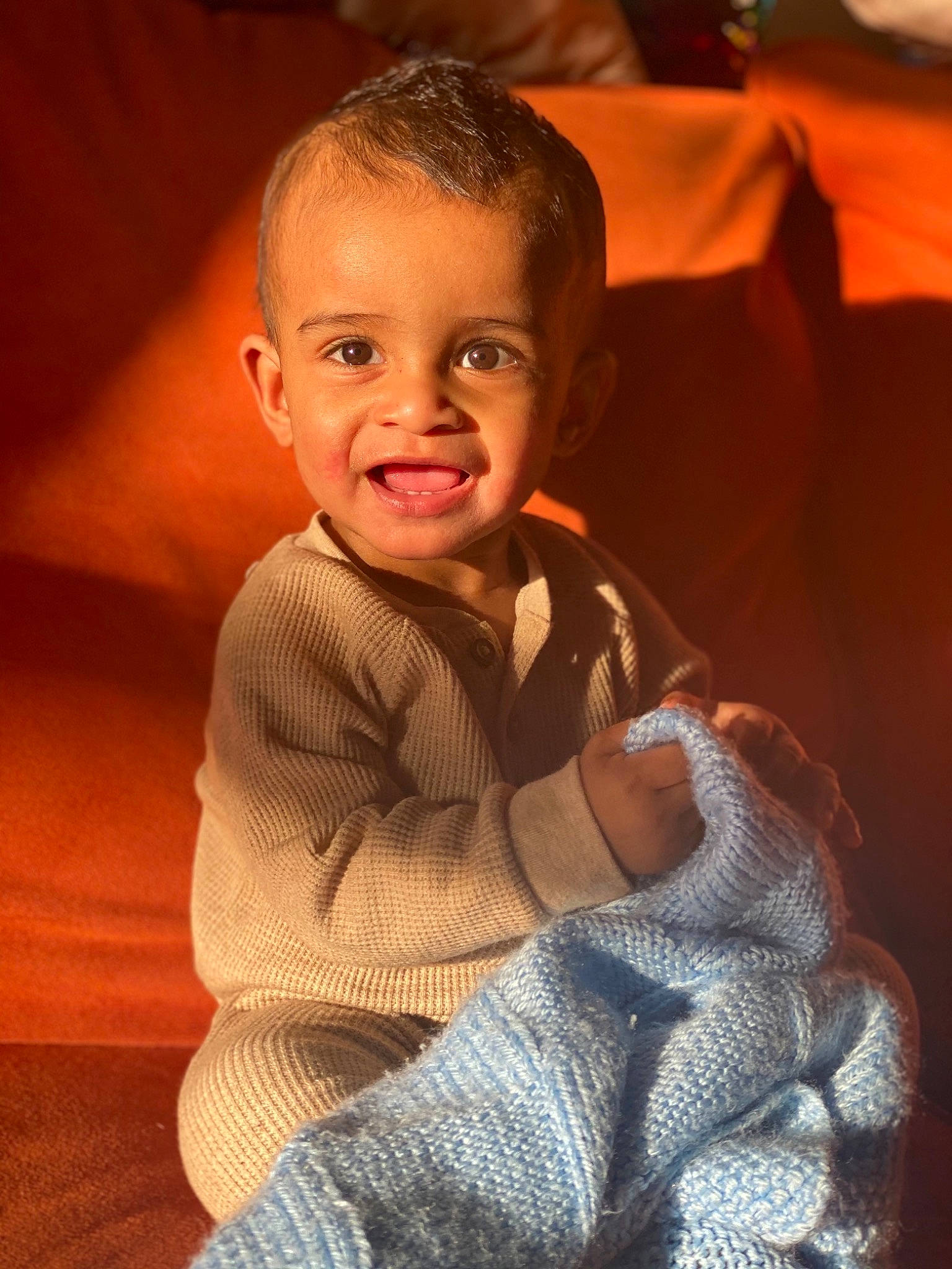 Legend is registered to the contest to win money with this photo: baby_toddler_clothing, cheek, comfort, elbow, eye, finger, flash_photography, flooring, gesture, happy, head, human_body, iris, joy, nose, person, skin, sleeve, smile, thumb