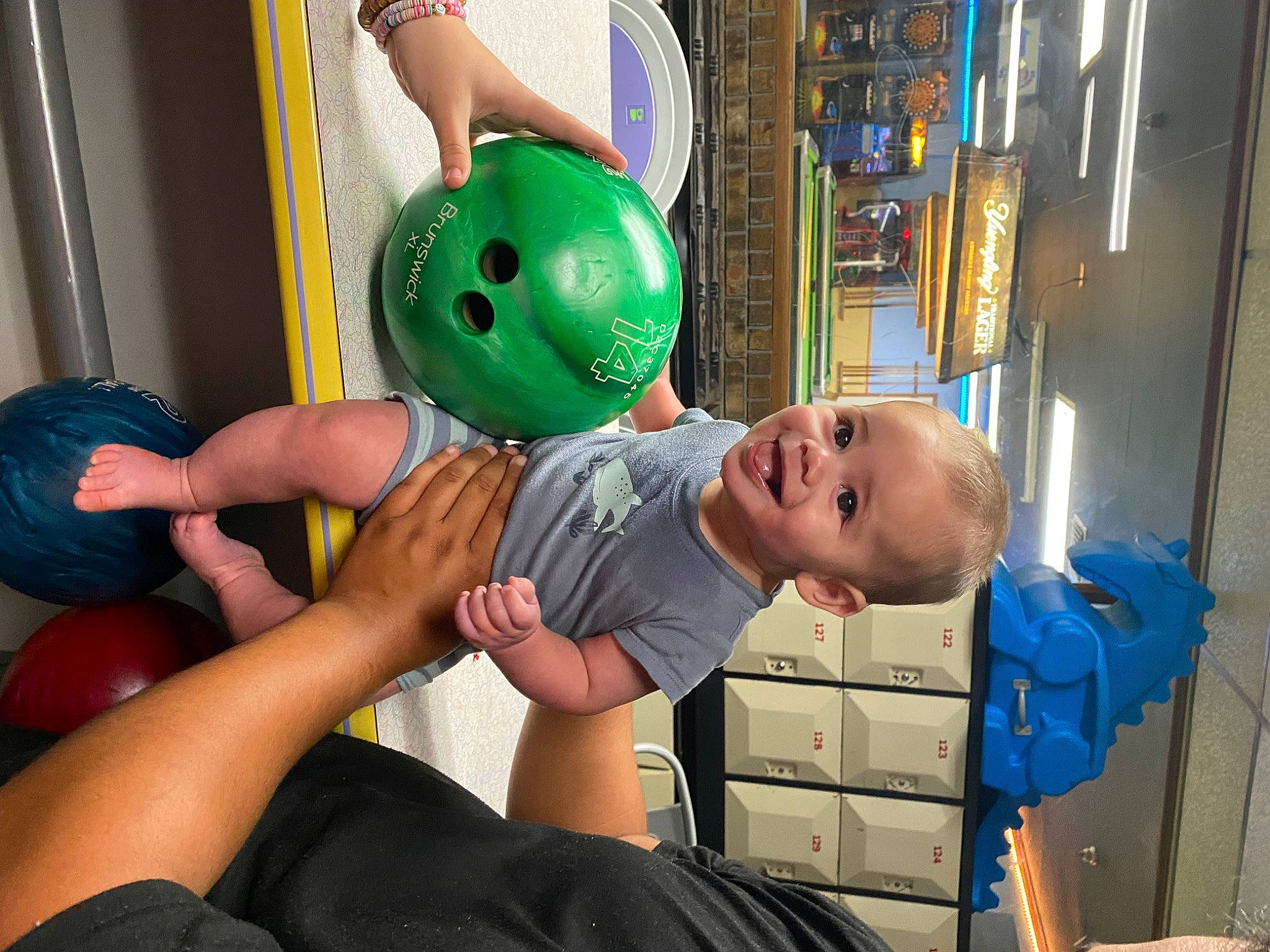 Jaylen is registered to the contest to win money with this photo: baby, ball, child, comfort, fun, happy, joint, joy, knee, leisure, party_supply, person, play, recreation, room, shelf, sitting, smile, sports_toy, t_shirt