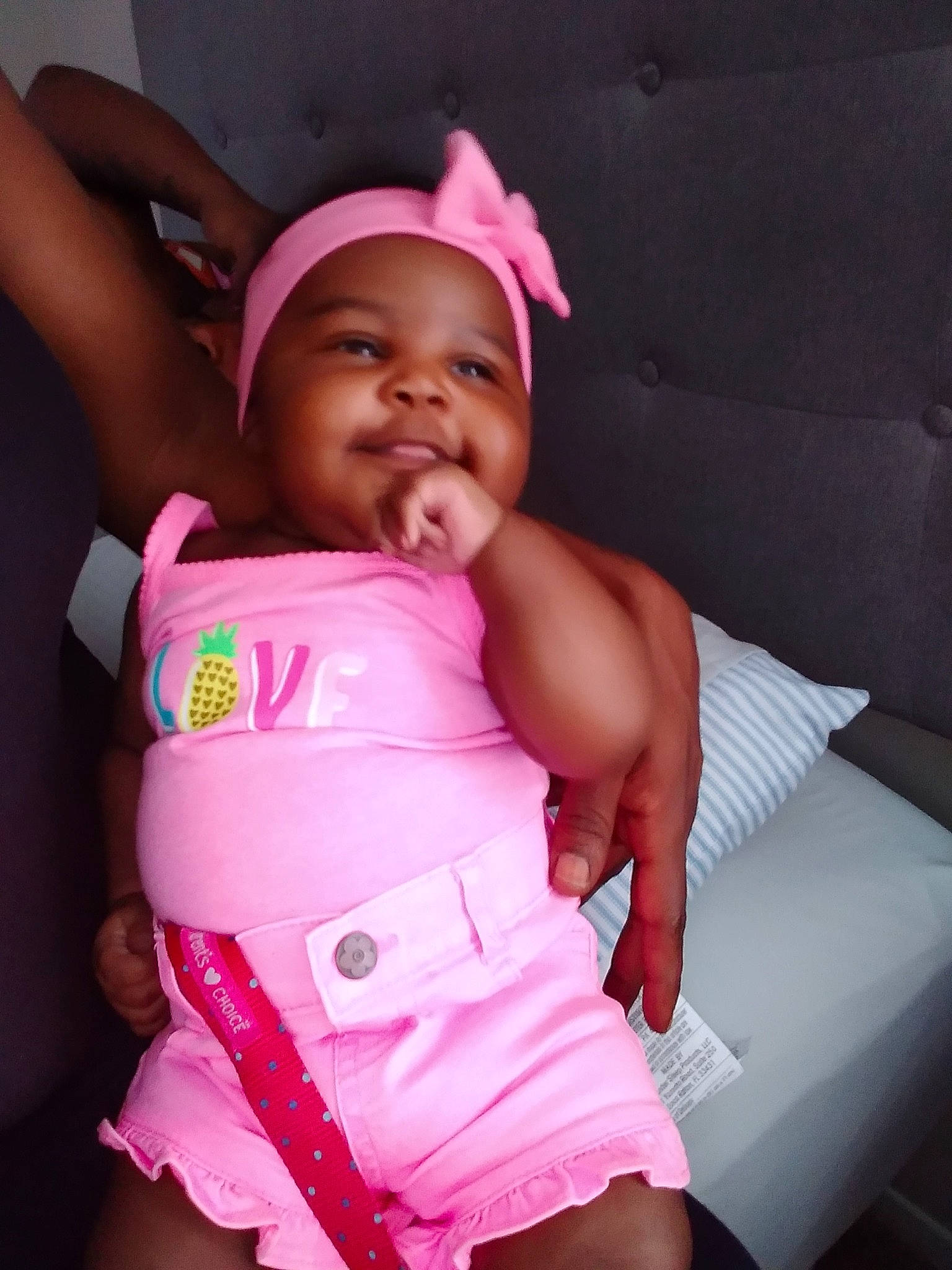 Babí is registered to the contest to win money with this photo: abdomen, baby, birth, cheek, child, finger, fun, headwear, leg, magenta, mouth, neck, person, pink, play, product, skin, thigh, thumb, toddler