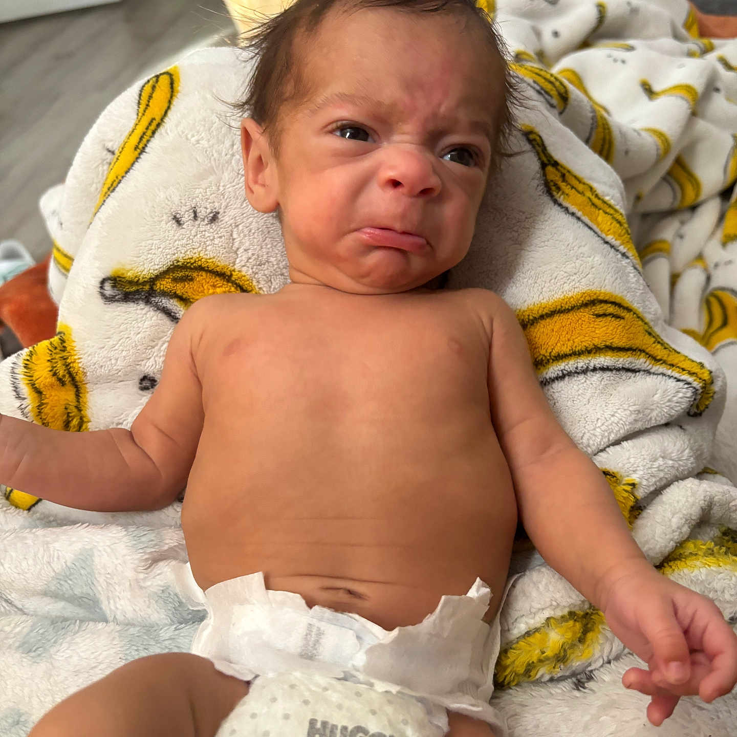 Kymeir Michael joined the competition — help win amazing prizes! baby, baby_boy, blanket, clothing, cute, diaper, expression, expression_of_displeasure, face, hand, indoor, infant, lying_down, newborn, person, skin, soft_texture, toddler, wrapped, young_child