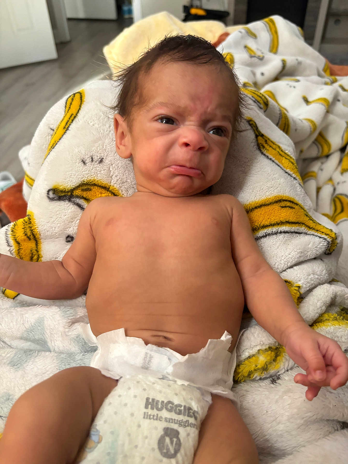 Kymeir Michael joined the competition — help win amazing prizes! baby, infant, diaper, blanket, face, expression, indoor, person, newborn, clothing, skin, hand, cute, lying_down, toddler, baby_boy, soft_texture, wrapped, expression_of_displeasure, young_child