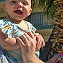 accessories, arm, baby, bodypart, bracelet, clothing, face, happy, head, jewelry, palmtree, person, photography, plant, portrait, pottedplant, shorts, smile, summer, tree