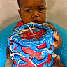 Makaio joined the competition — help win amazing prizes! baby, child, cake, blue_icing, red_icing, birthday_cake, hand, face, sitting, seat, celebration, food, dessert, colorful, portrait, indoor, person, young_child, holding, closeup