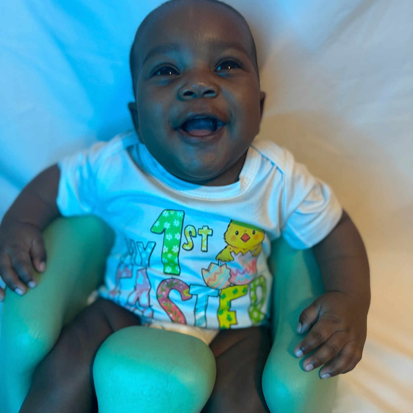 Makaio is registered to the contest to win money with this photo: baby, smiling, sitting, baby_seat, clothing, toddler, happy, infant, face, child, one_year_old, easter, colorful, cute, indoors, portrait, young_child, bright, cheerful, skin