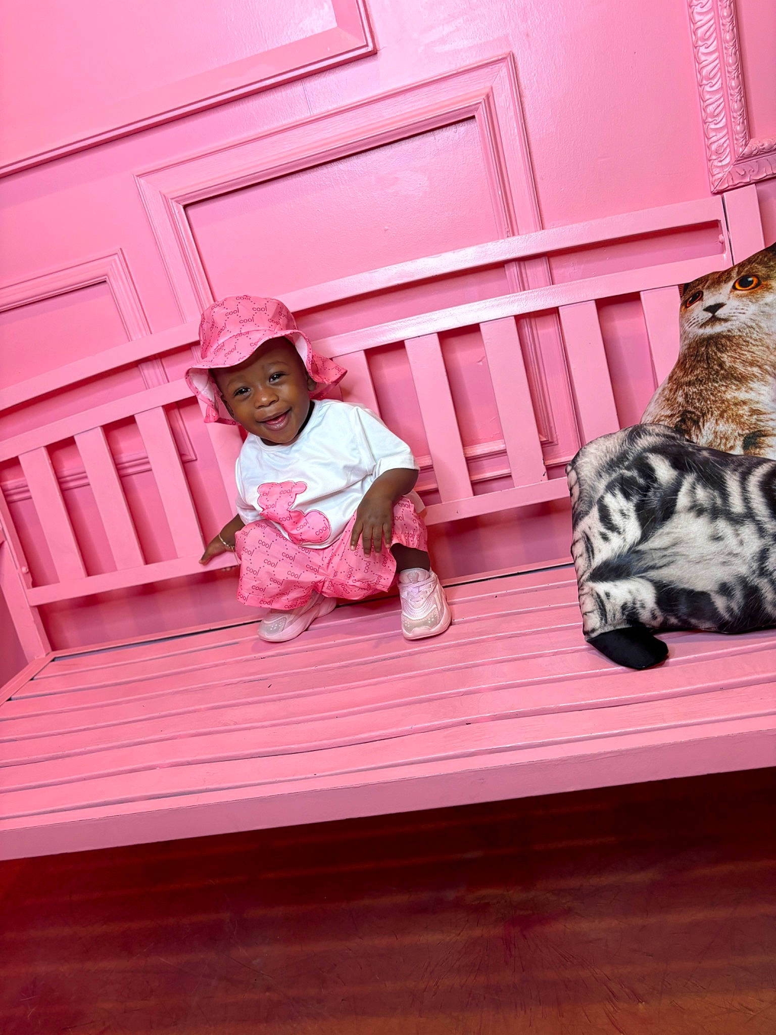 Kmora is registered to the contest to win money with this photo: cat, door, felidae, floor, flooring, fun, happy, hardwood, headwear, joy, magenta, mammal, pattern, person, pink, room, shoe, small_to_medium_sized_cats, t_shirt, tints_and_shades