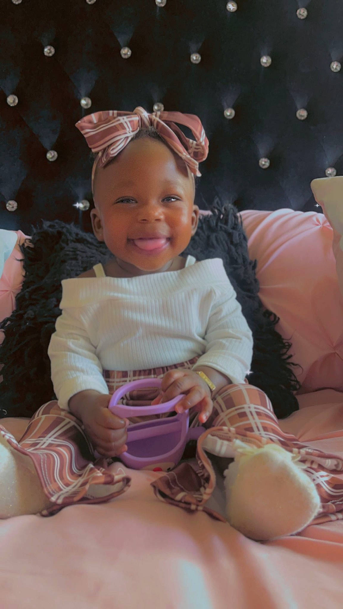 Kmora is registered to the contest to win money with this photo: baby, baby_toddler_clothing, cheek, child, comfort, facial_expression, fun, happy, head, human, human_leg, joy, lap, person, pink, purple, sitting, skin, smile, sock