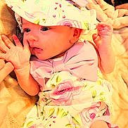 Lilly Rose Pfaff joined the competition — help win amazing prizes! baby, infant, hat, bow, floral_pattern, clothing, hand, finger, blanket, soft_texture, cute, portrait, newborn, pink, skin, face, eyes, expression, lying_down, person