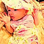 baby, infant, hat, bow, floral_pattern, clothing, hand, finger, blanket, soft_texture, cute, portrait, newborn, pink, skin, face, eyes, expression, lying_down, person