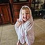 toddler, child, blanket, pink, smiling, happy, indoor, tile_floor, barefoot, cabinet, furniture, home, portrait, cute, wrapped, young_child, expression, joyful, face, standing