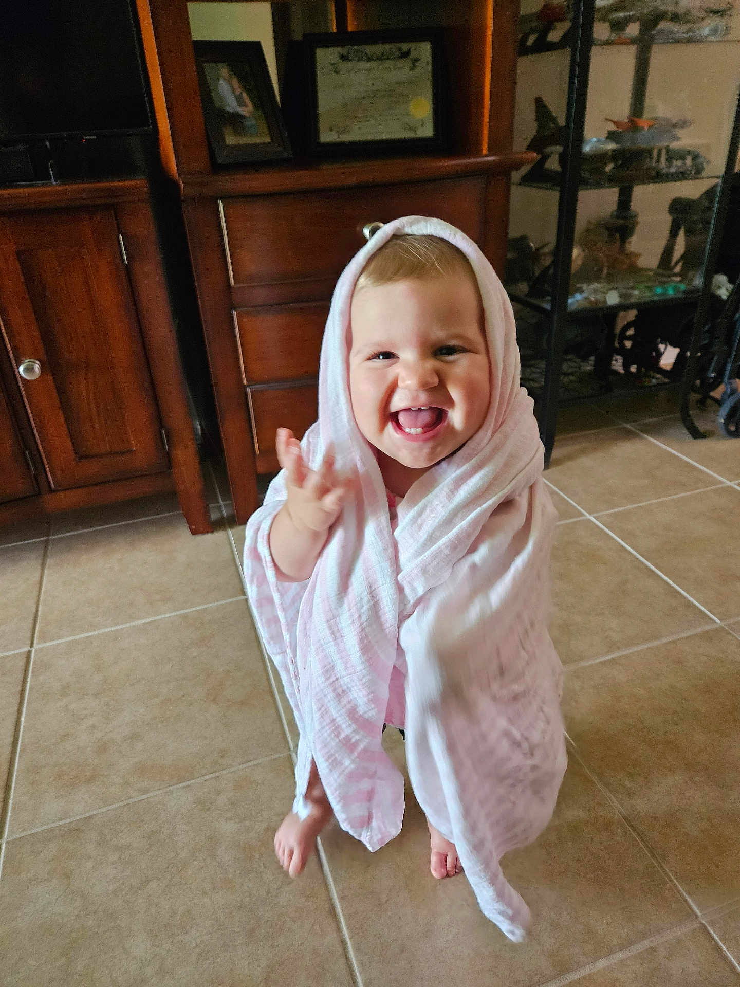 Freya joined the competition — help win amazing prizes! toddler, child, blanket, pink, smiling, happy, indoor, tile_floor, barefoot, cabinet, furniture, home, portrait, cute, wrapped, young_child, expression, joyful, face, standing