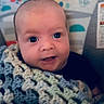 baby, infant, face, blanket, knitted_blanket, smile, happy, closeup, cute, child, portrait, indoors, young_child, colorful_background, eyes, head, skin, person, warm, cozy