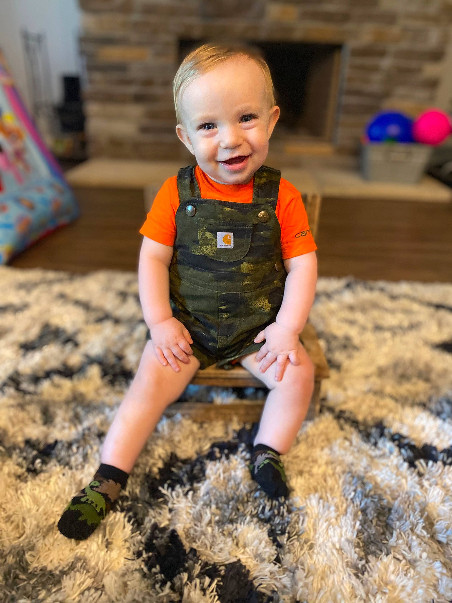 Jensen is registered to the contest to win money with this photo: baby_toddler_clothing, child, eye, face, flash_photography, flooring, fun, grass, hairstyle, happy, head, joy, orange, people, people_in_nature, person, shorts, sleeve, smile, summer