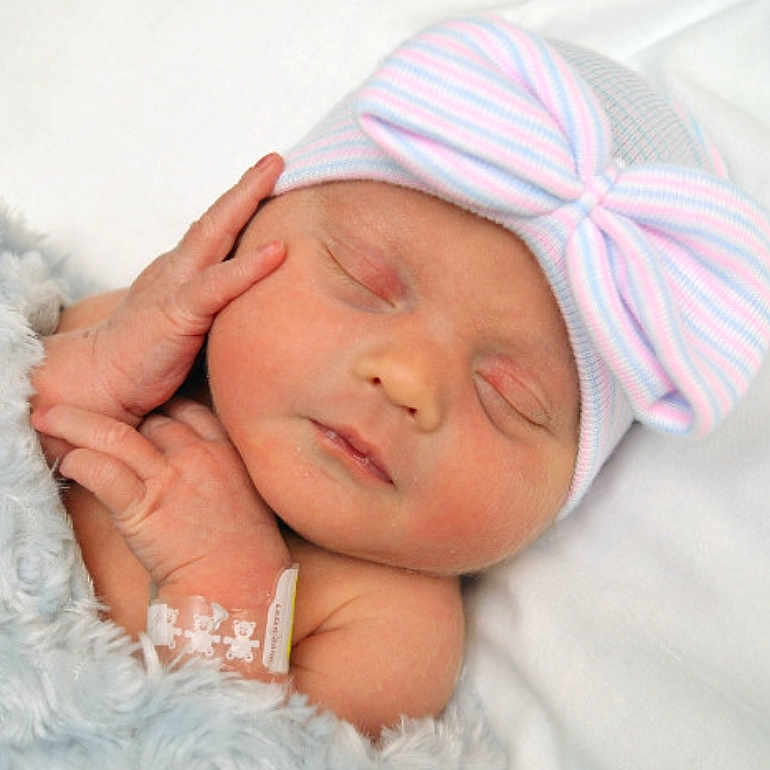 Meredith joined the competition — help win amazing prizes! architecture, baby, blanket, bodypart, bonnet, building, cap, clothing, face, finger, glove, hand, hat, head, hospital, newborn, person, photography, portrait, sleeping