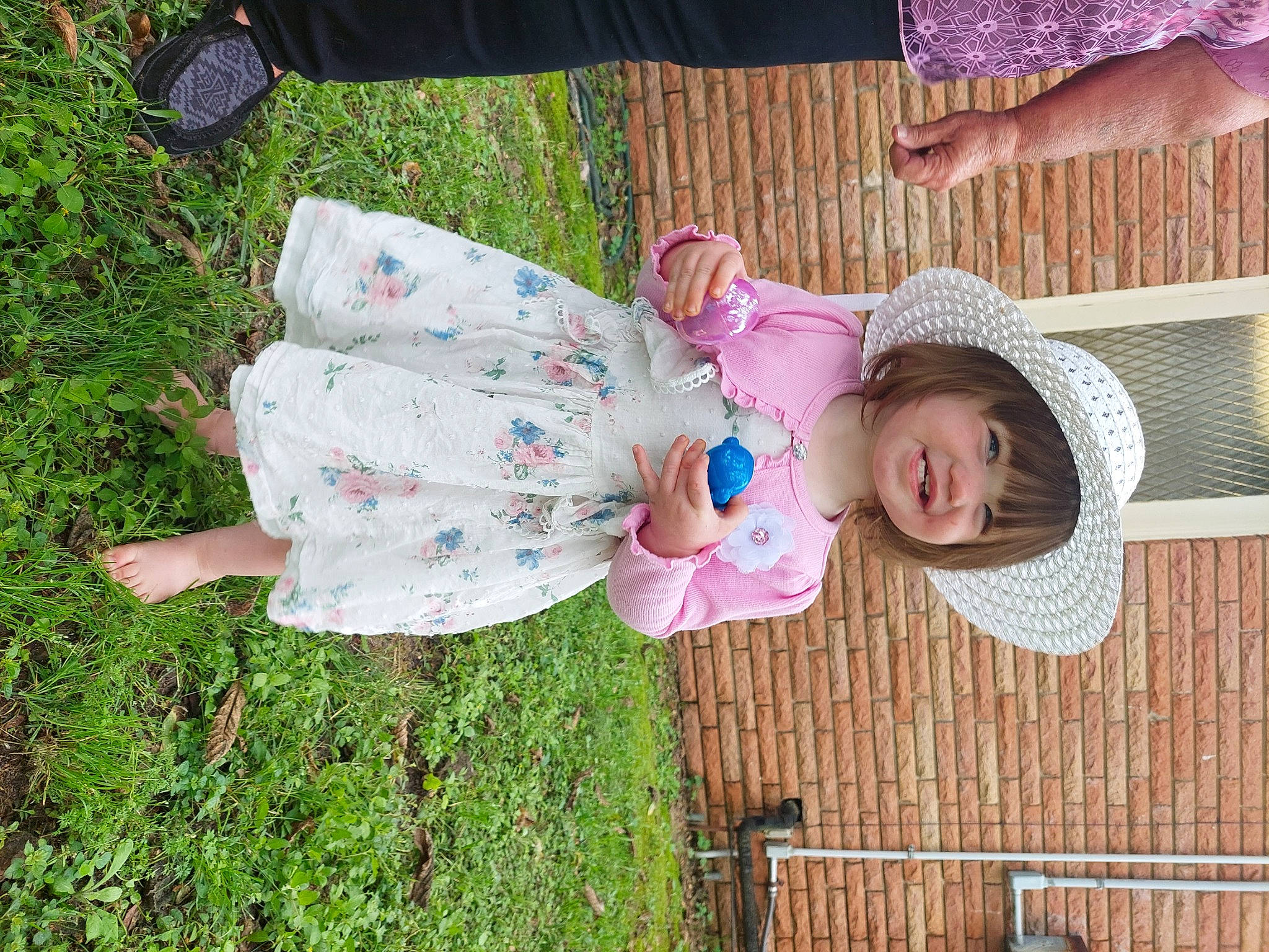 Angel is registered to the contest to win money with this photo: baby, baby_toddler_clothing, cap, child, cowboy_hat, fashion_accessory, fun, grass, green, happy, hat, joy, leisure, pattern, person, pink, plant, sitting, sun_hat, toddler
