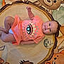 baby, infant, orange_clothing, smiling, animal_rug, milestone_marker, foot, toenail_paint, diaper, cute, lying_down, child, indoor, play_mat, colorful, decorative_rug, person, young_baby, three_months, happy