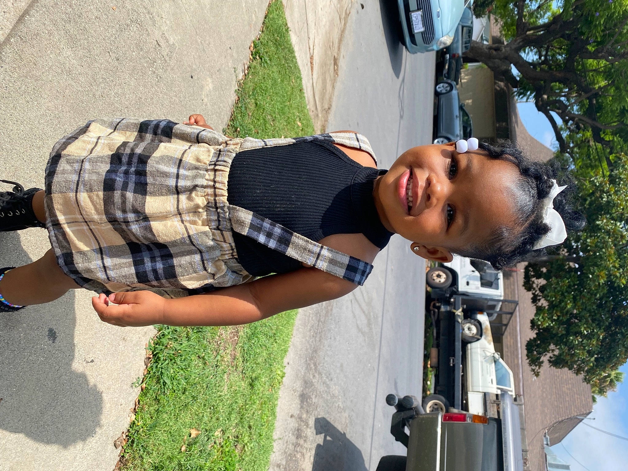 Myrah is registered to the contest to win money with this photo: asphalt, automotive_lighting, car, cool, eyewear, grass, human_leg, joy, knee, pattern, person, plaid, plant, recreation, sky, smile, tartan, thigh, tree, vehicle