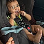 Aislynn joined the competition — help win amazing prizes! toddler, child, car_seat, seatbelt, lollipop, smiling, happy, curly_hair, barefoot, inside_car, black_car_seat, safety, cute, playful, young_child, car_interior, seat, infant, baby, person