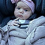 Anya joined the competition — help win amazing prizes! baby, infant, car_seat, blanket, headband, pink, pacifier, knitted, serious_expression, child, toddler, clothing, seatbelt, cute, indoor, portrait, person, baby_accessory, fabric, closeup