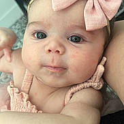 Anya is registered to the contest to win money with this photo: adorable, apparel, arm, baby, child, closeup, clothing, cute, expression, face, headband, indoors, infant, newborn, person, pink_bow, portrait, skin, soft_light, young
