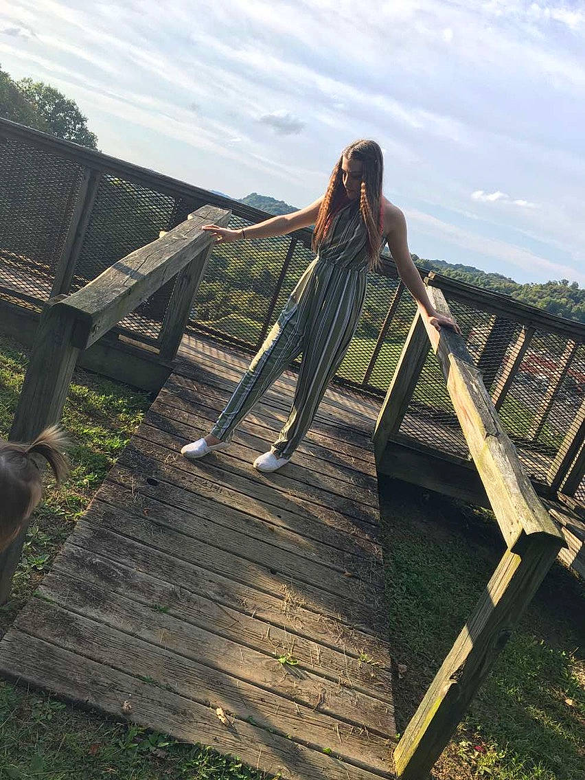 Terri is registered to the contest to win money with this photo: beauty, bridge, dock, dress, forest, grass, leisure, nonbuilding_structure, person, photo_shoot, photography, plant, river, sitting, sky, tree, water, wood