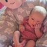 Melody is registered to the contest to win money with this photo: newborn, baby, infant, child, sitting, smiling, winking, plush_toy, stuffed_animal, elephant_pattern, onesie, red_clothing, barefoot, nursery, baby_seat, cushion, portrait, indoors, cozy, happy