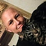 Tigi Roo joined the competition — help win amazing prizes! animal, black_clothing, blonde_hair, casual, cat, closeup, companion, cozy, face, feline, friendly, hair_bun, home, indoor, person, pet, portrait, smile, tabby_cat, warm