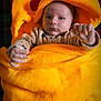Arthur participe au concours pour gagner de l'argent avec cette photo : baby, child, blanket, yellow, pikachu, hood, plush, cozy, face, hands, red, plaid, pattern, bed, soft, warm, person, infant, cute, indoor