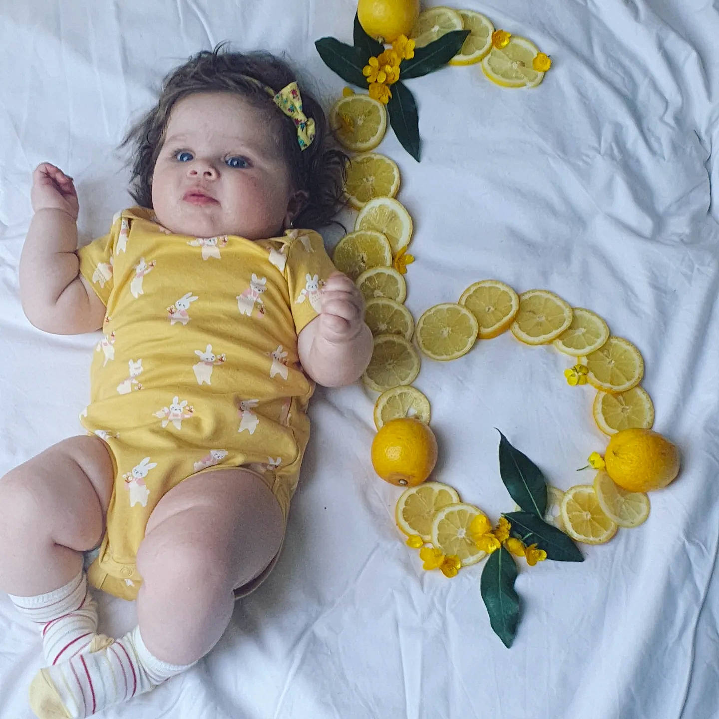 Vanessa a rejoint le concours — aidez-le/la à gagner de superbes lots ! baby, baby_products, baby_toddler_clothing, baby_toys, doll, eye, foot, happy, human_leg, linens, pattern, person, sitting, sleeve, stuffed_toy, textile, thigh, thumb, toddler, toy
