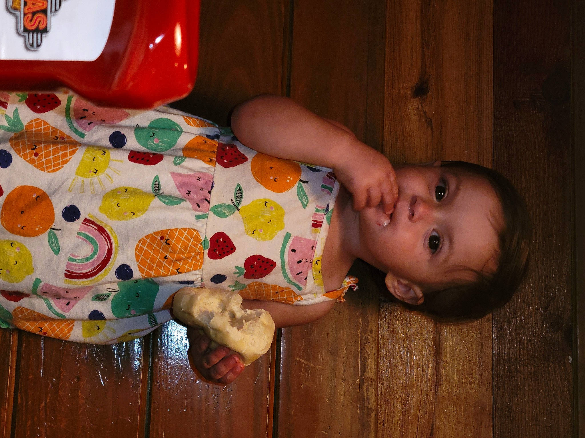 Eloisa is registered to the contest to win money with this photo: baby, baby_toddler_clothing, carmine, cheek, child, finger, floor, flooring, fun, hardwood, human_leg, mouth, nose, orange, person, room, textile, toddler, toy, vertebrate