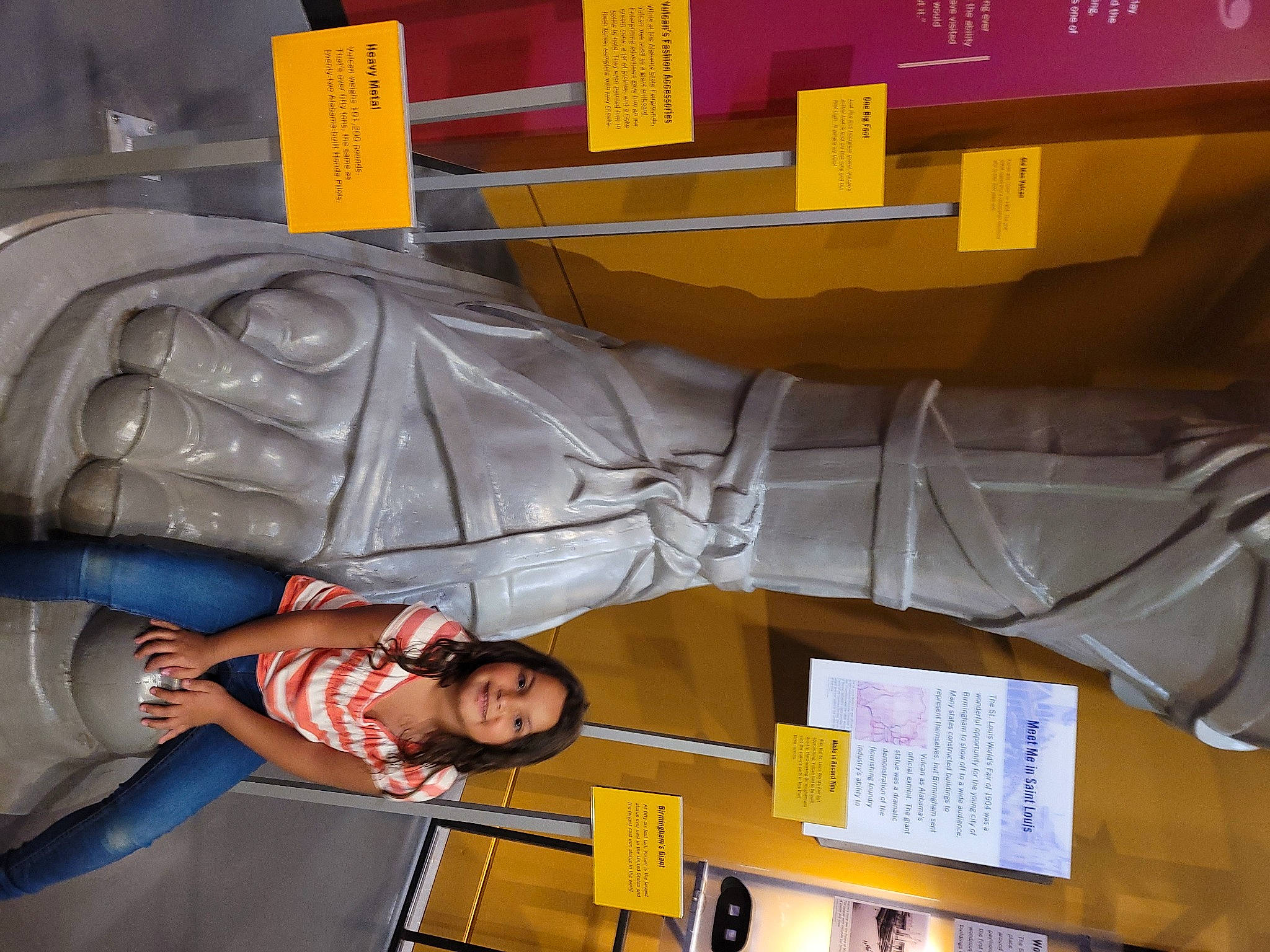 Madison is registered to the contest to win money with this photo: art, automotive_design, engineering, fictional_character, font, fun, joy, leg, metal, person, photograph, plastic, product, room, sculpture, smile, snapshot, statue, suit, sunglasses