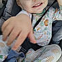 toddler, child, smiling, pajamas, animal_print, stroller, seatbelt, blanket, hand, face, happy, young_child, outdoor, cute, infant, baby, clothing, seat, comfort, playful