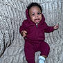 Joshua joined the competition — help win amazing prizes! baby, child, infant, hoodie, clothing, maroon, socks, blanket, fabric, texture, happy, smiling, person, cute, indoor, portrait, young, sitting, cozy, soft