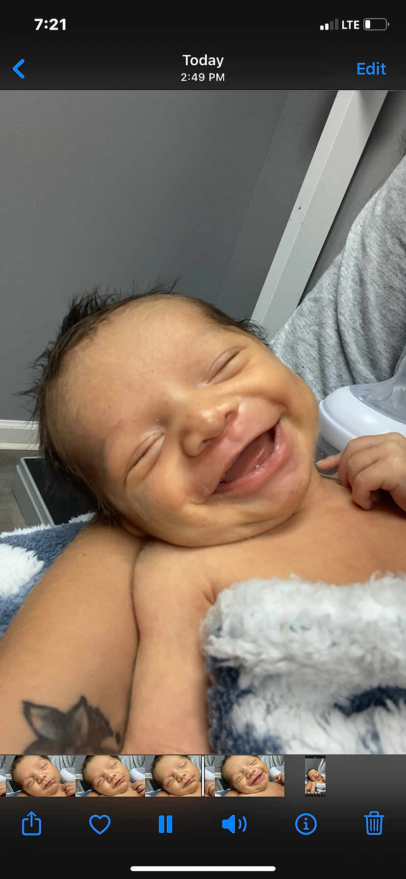 Raul is registered to the contest to win money with this photo: baby, smiling, infant, blanket, arm, tattoo, person, skin, happy, indoors, face, closeup, newborn, resting, cozy, child, human, comfort, expression, portrait