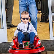 Noah joined the competition — help win amazing prizes! child, toddler, toy_car, sunglasses, adult, remote_control, white_shirt, blue_jeans, indoor, flooring, wooden_floor, person, cool, serious_face, funny, photography, event, people, casual_clothing, technology