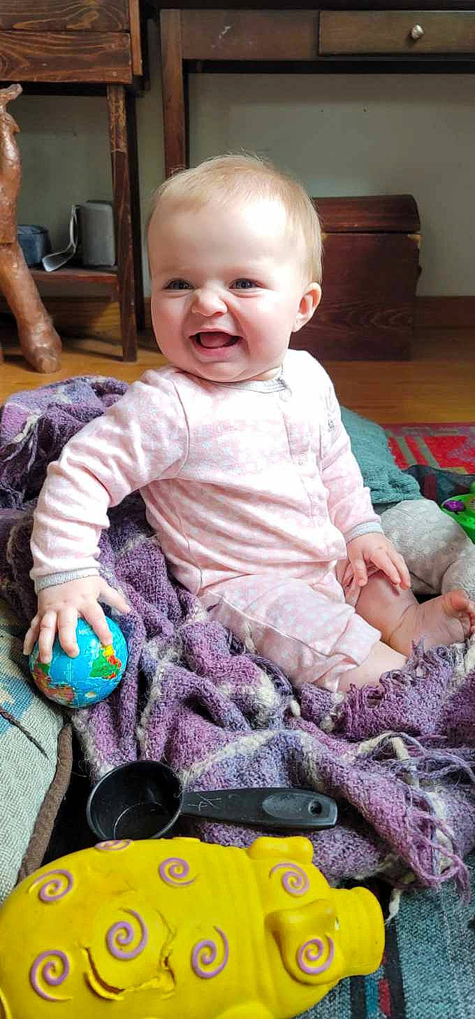 Eden joined the competition — help win amazing prizes! baby, baby_products, baby_toddler_clothing, cheek, child, comfort, finger, happy, iris, joy, pattern, person, product, purple, room, sitting, skin, sleeve, smile, t_shirt