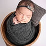 baby, newborn, sleeping, swaddled, blanket, headband, flower, bucket, wooden, pillow, cozy, cute, infant, portrait, soft, peaceful, resting, indoors, child, adorable
