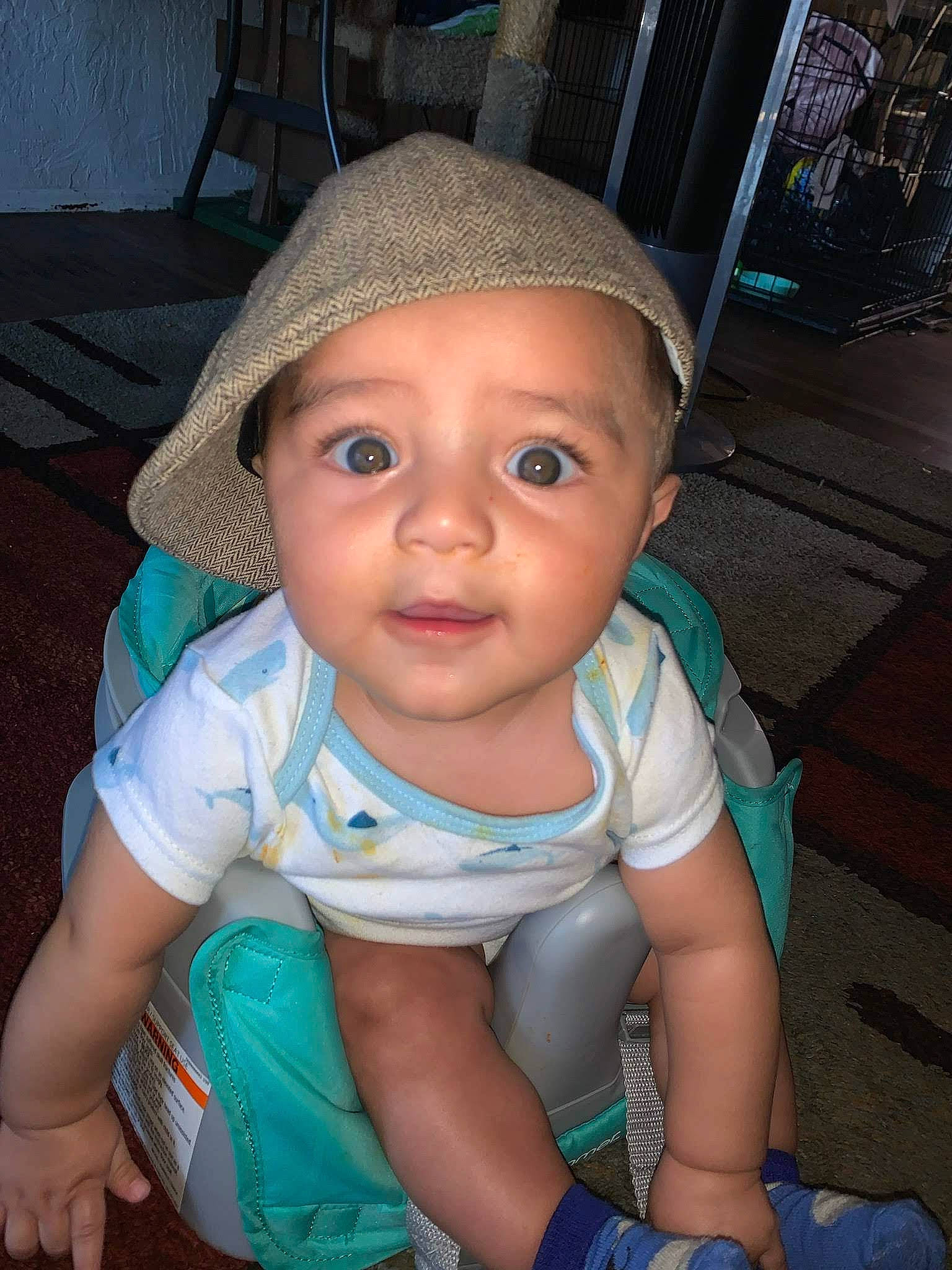 Daniel is registered to the contest to win money with this photo: baby, baby_toddler_clothing, cap, cheek, child, chin, eye, eyebrow, eyelash, fun, happy, headwear, iris, lip, mouth, nose, person, sitting, skin, smile
