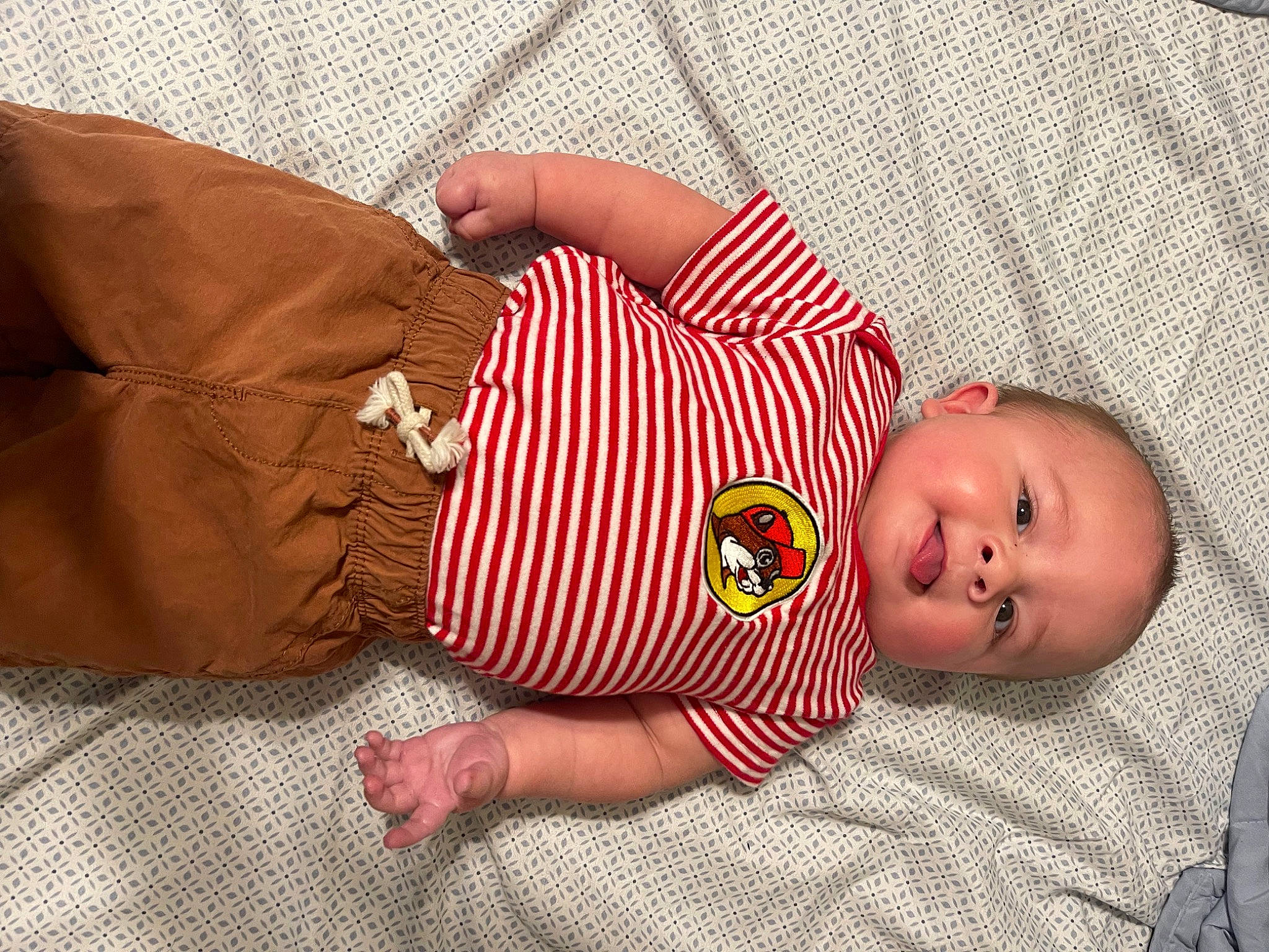 Judson is registered to the contest to win money with this photo: baby, baby_products, baby_sleeping, baby_toddler_clothing, bedding, bedtime, child, comfort, couch, linens, mammal, pattern, person, red, room, skin, sleeve, textile, toddler, wood