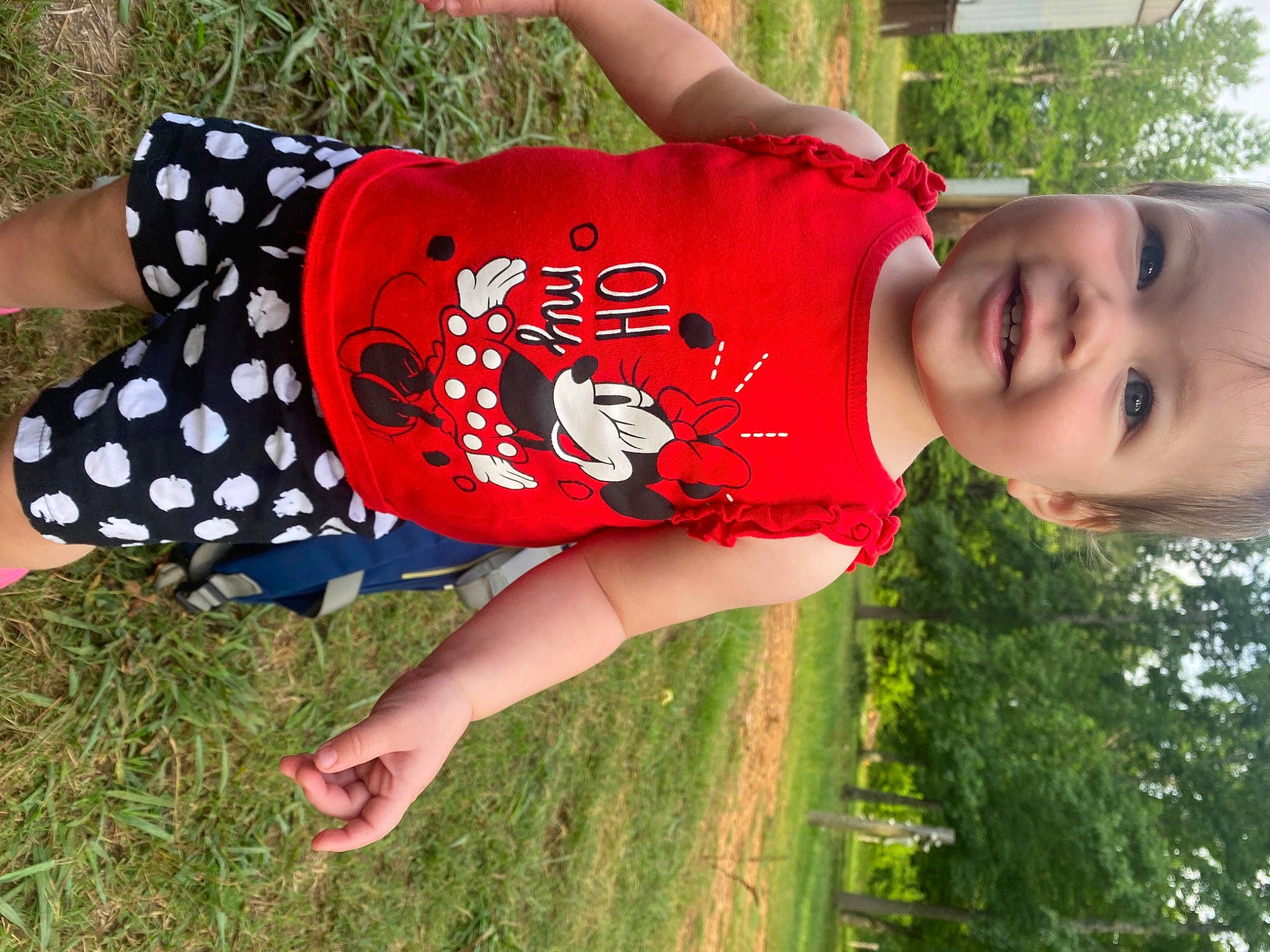 Isla is registered to the contest to win money with this photo: cool, fun, grass, green, happy, joint, joy, knee, leisure, people_in_nature, person, plant, red, sleeve, smile, thigh, toddler, tree, trunk, waist